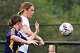 Marquette's Emily Hough (right) and Allie Kamp of CM eye the ball during agame at Hauser Field in Bethalto.