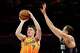 Charlotte Hornets guard Kon Knueppel (7) looks to shoot against Detroit Pistons forward Duncan Robinson, right, during the first half of an NBA basketball game in Charlotte, N.C., Friday, April 10, 2026.
