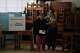 A family member helps a woman vote as voting resumes at a polling station affected by delays and logistical problems during the general elections in Lima, Peru, Monday, April 13, 2026. (AP Photo/Guadalupe Pardo)