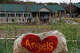 A heart-painted rock is shown across the Guadalupe River from Camp Mystic in Hunt, where 27 campers and counselors died in the flood last summer.