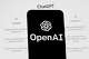 FILE - The OpenAI logo is seen on a mobile phone in front of a computer screen which displays the ChatGPT home Screen, March 17, 2023, in Boston.