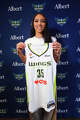 Dallas Wings guard Azzi Fudd, the No. 1 overall pick in the WNBA basketball draft, poses with a team jersey after an introductory news conference, Thursday, April 16, 2026, in Dallas. (AP Photo/LM Otero)