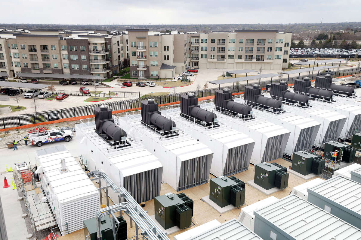 Apartments sit across the street from Dallas TX4, the fourth and final new data center building under construction at the NTT Data center campus in Garland, Texas, March 4, 2026. A row of diesel powered back-up generators in the foreground are being prepared to go online.