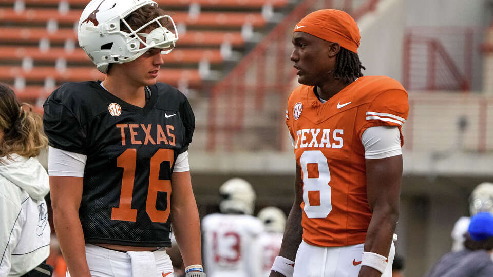 Texas Longhorns quarterback Arch Manning (16) talks to receiver Cam Coleman (8) during practice on fan day at Darrell K Royal–Texas Memorial Stadium on Saturday, Aril 18, 2026 in Austin.