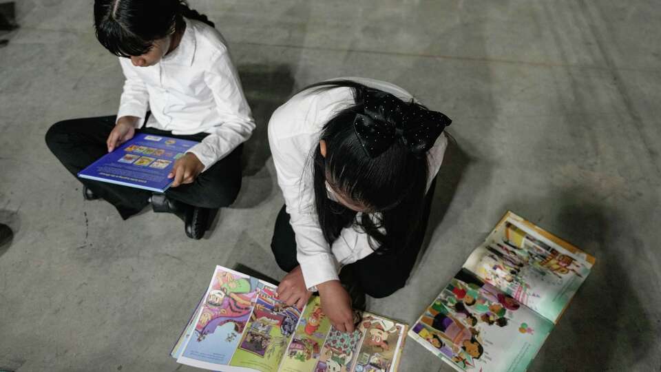 Diana Cuevas, 10, and Ketzali Solís, 10, read books during Aldine ISD’s fifth annual bilingual festival in Houston on Saturday, April 18, 2026.