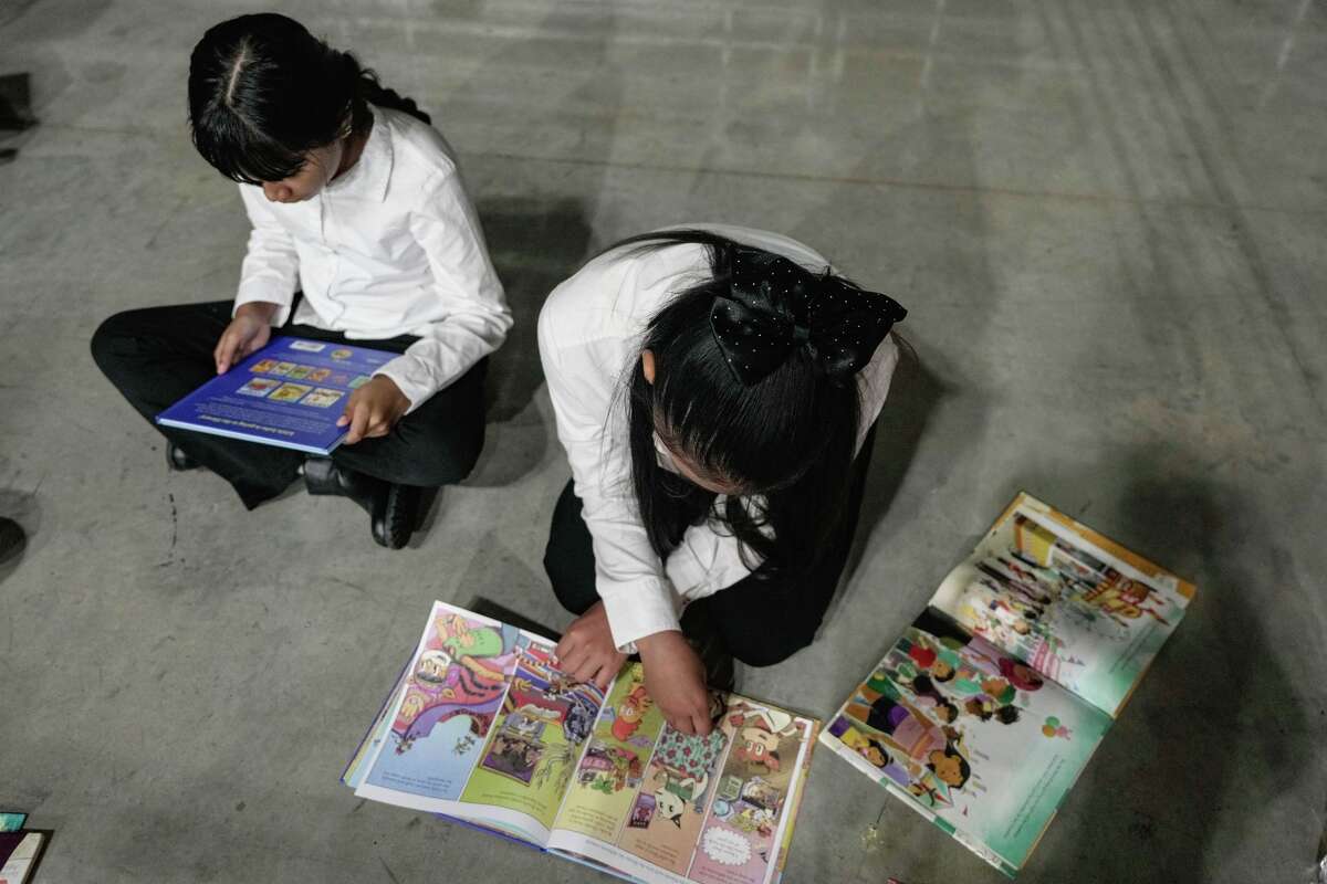 Diana Cuevas, 10, and Ketzali Solís, 10, read books during Aldine ISD’s fifth annual bilingual festival in Houston on Saturday, April 18, 2026.