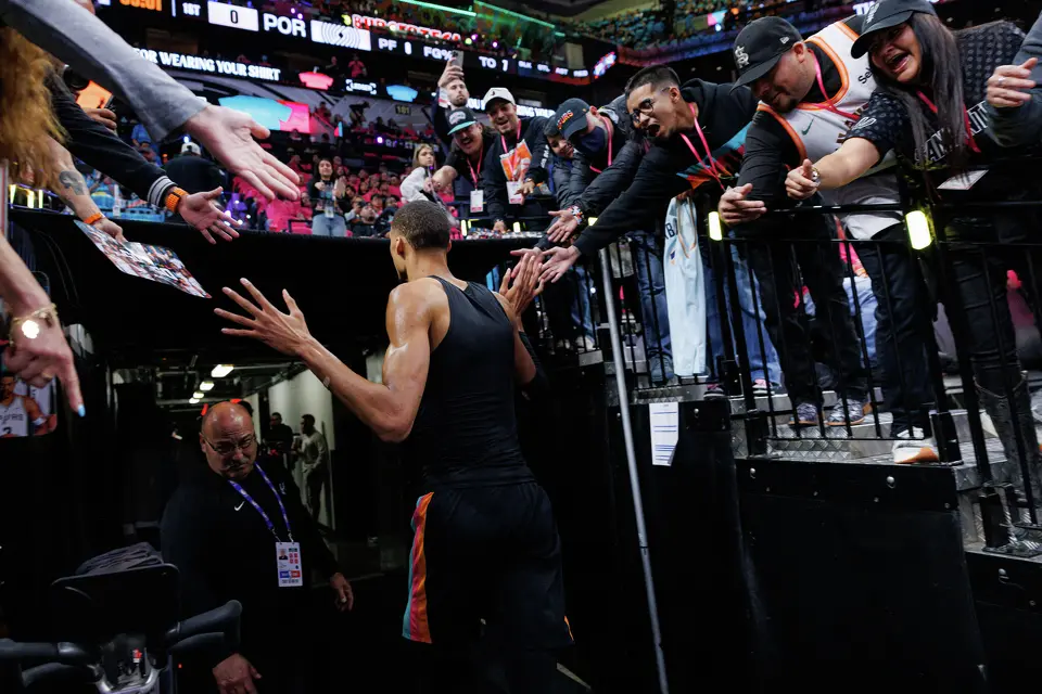 San Antonio Spurs forward Victor Wembanyama (1) slaps hands with cheering fans as he runs back to the locker room before the start of Game 1 of a first-round NBA playoff series against the Portland Trail Blazers at Frost Bank Center, Sunday, April 19, 2026, in San Antonio.