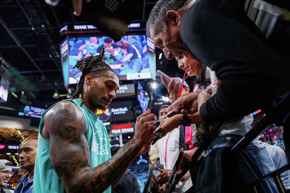San Antonio Spurs guard Devin Vassell signs autographs for fans before the start of Game 1 of a first-round NBA playoff series against the Portland Trail Blazers at Frost Bank Center, Sunday, April 19, 2026, in San Antonio.