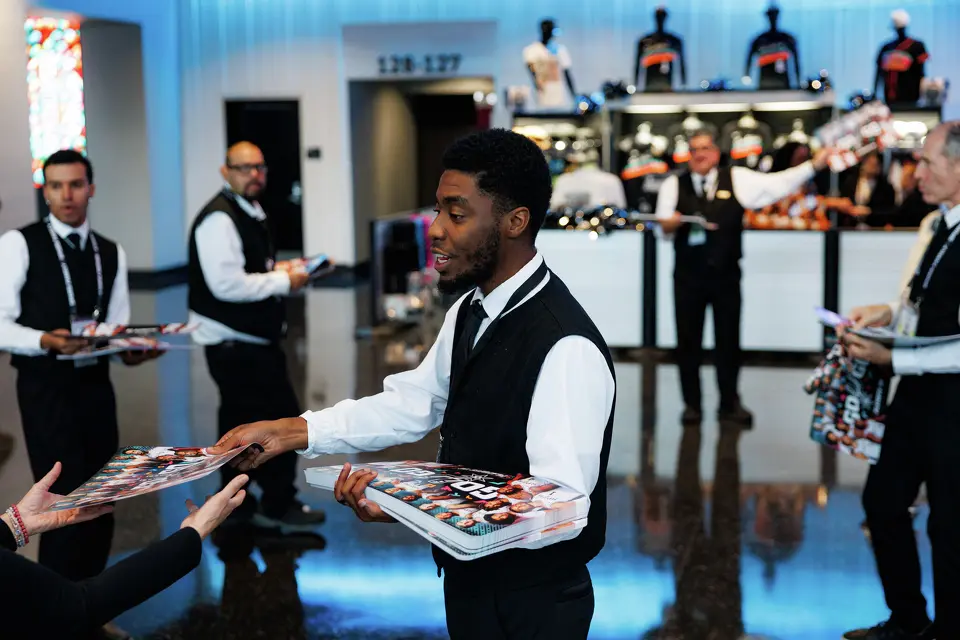Demetrius Davis hands out noise makers to San Antonio Spurs fans as they make their way into Frost Bank Center before the start of Game 1 of a first-round NBA playoff series against the Portland Trail Blazers on Sunday, April 19, 2026, in San Antonio.