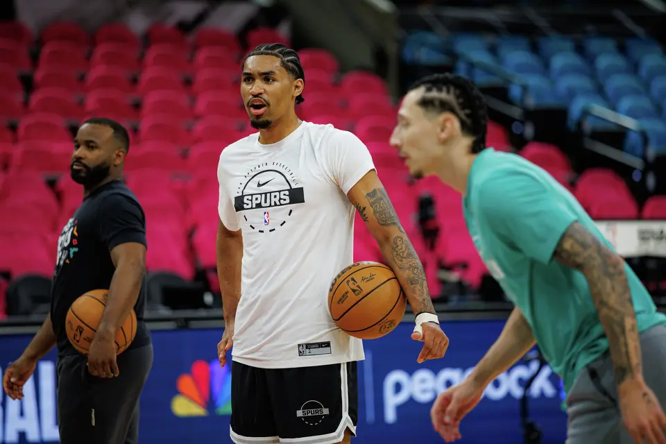 San Antonio Spurs guard Dylan Harper, center, warms up on the court with his teammates before the start of Game 1 of a first-round NBA playoff series against the Portland Trail Blazers at Frost Bank Center, Sunday, April 19, 2026, in San Antonio.