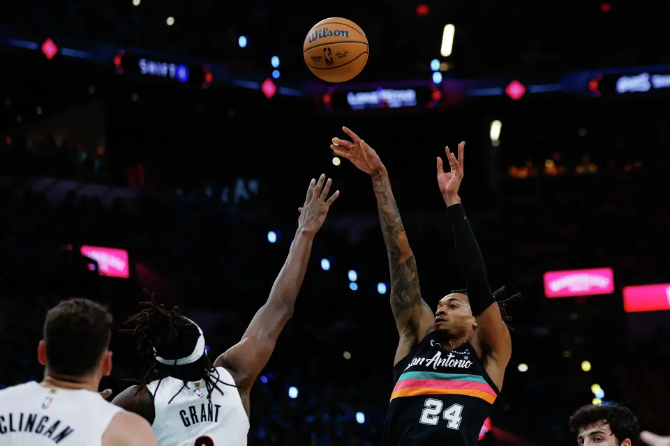San Antonio Spurs guard Devin Vassell (24) shoots over Portland Trail Blazers forward Jerami Grant (9) during the first half of Game 1 of a first-round NBA playoff series at Frost Bank Center, Sunday, April 19, 2026, in San Antonio.