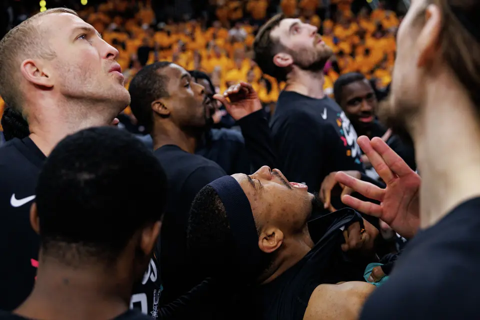 San Antonio Spurs forward Keldon Johnson, bottom center, leads his teammates in a chant before taking on the Portland Trail Blazers in Game 1 of a first-round NBA playoff series at Frost Bank Center, Sunday, April 19, 2026, in San Antonio.