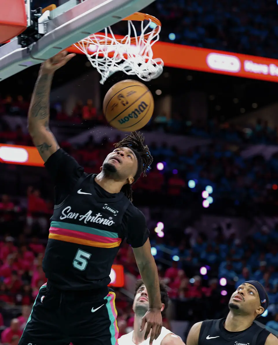 San Antonio Spurs guard Stephon Castle (5) slams the ball in during the first half of Game 1 of a first-round NBA playoff series against the Portland Trail Blazers at Frost Bank Center, Sunday, April 19, 2026, in San Antonio.