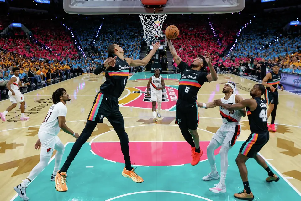 San Antonio Spurs forward Victor Wembanyama (1) and guard Stephon Castle (5) go up for the rebound during Game 1 of a first-round NBA playoff series against the Portland Trail Blazers at Frost Bank Center, Sunday, April 19, 2026, in San Antonio. The Spurs won 111-98.