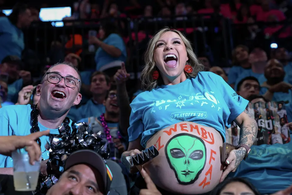 Pregnant Spurs fan Hailey Rinewalt cheers after appearing on the video board during the third quarter of Game 1 of a first-round NBA playoff series against the against the Portland Trail Blazers at Frost Bank Center on Sunday, April 19, 2026, in San Antonio. Rinewalt said she loves Victor Wembanyama and is due in eight days.