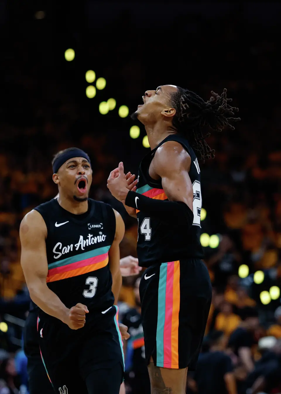 San Antonio Spurs forward Keldon Johnson (3) and San Antonio Spurs guard Devin Vassell (24) react during the second half of Game 1 of a first-round NBA playoff series against the Portland Trail Blazers at Frost Bank Center, Sunday, April 19, 2026, in San Antonio. The Spurs won 111-98.