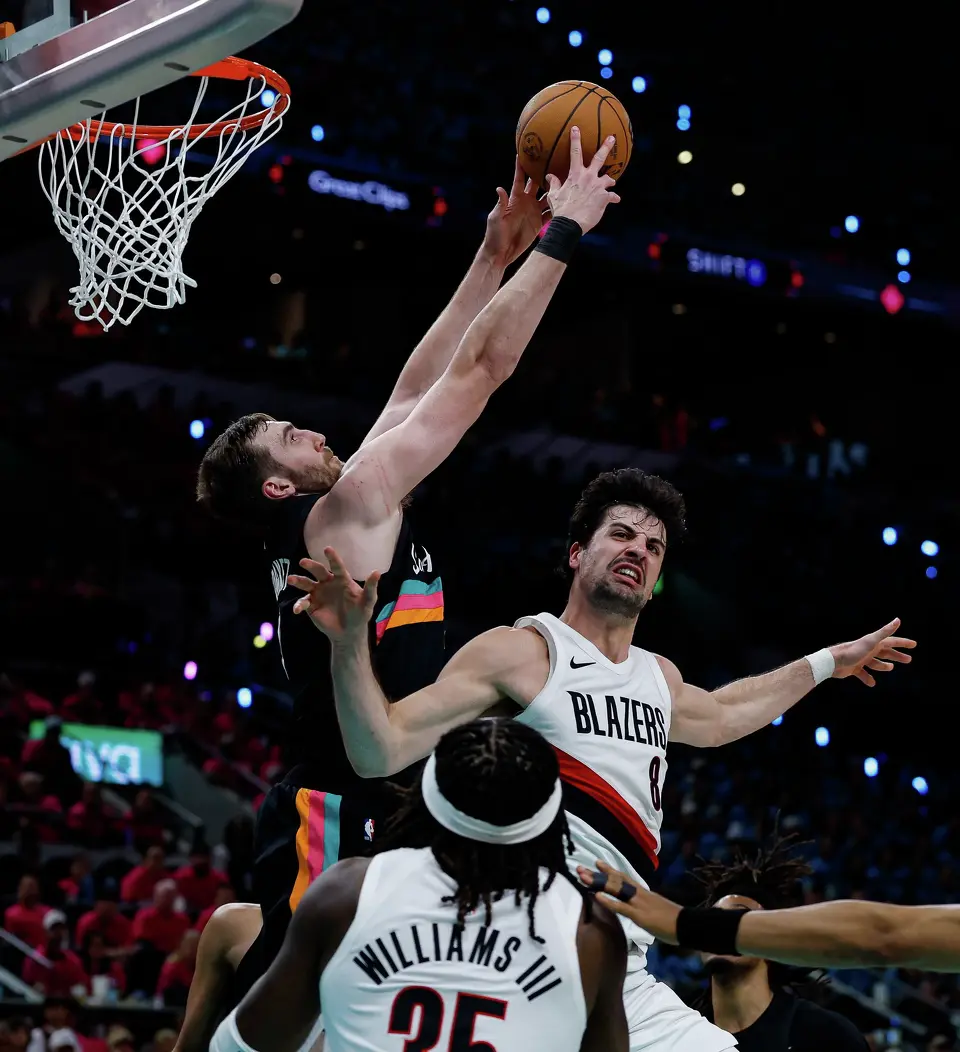 San Antonio Spurs center Luke Kornet (7) blocks a shot attempt by Portland Trail Blazers forward Deni Avdija (8) during the second half of Game 1 of a first-round NBA playoff series at Frost Bank Center, Sunday, April 19, 2026, in San Antonio. The Spurs won 111-98.
