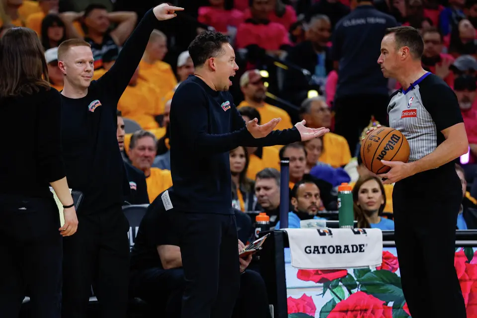 San Antonio Spurs head coach Mitch Johnson, center, argues with referee Josh Tiven (58) during the second half of Game 1 of a first-round NBA playoff series against the Portland Trail Blazers at Frost Bank Center, Sunday, April 19, 2026, in San Antonio. The Spurs won 111-98.