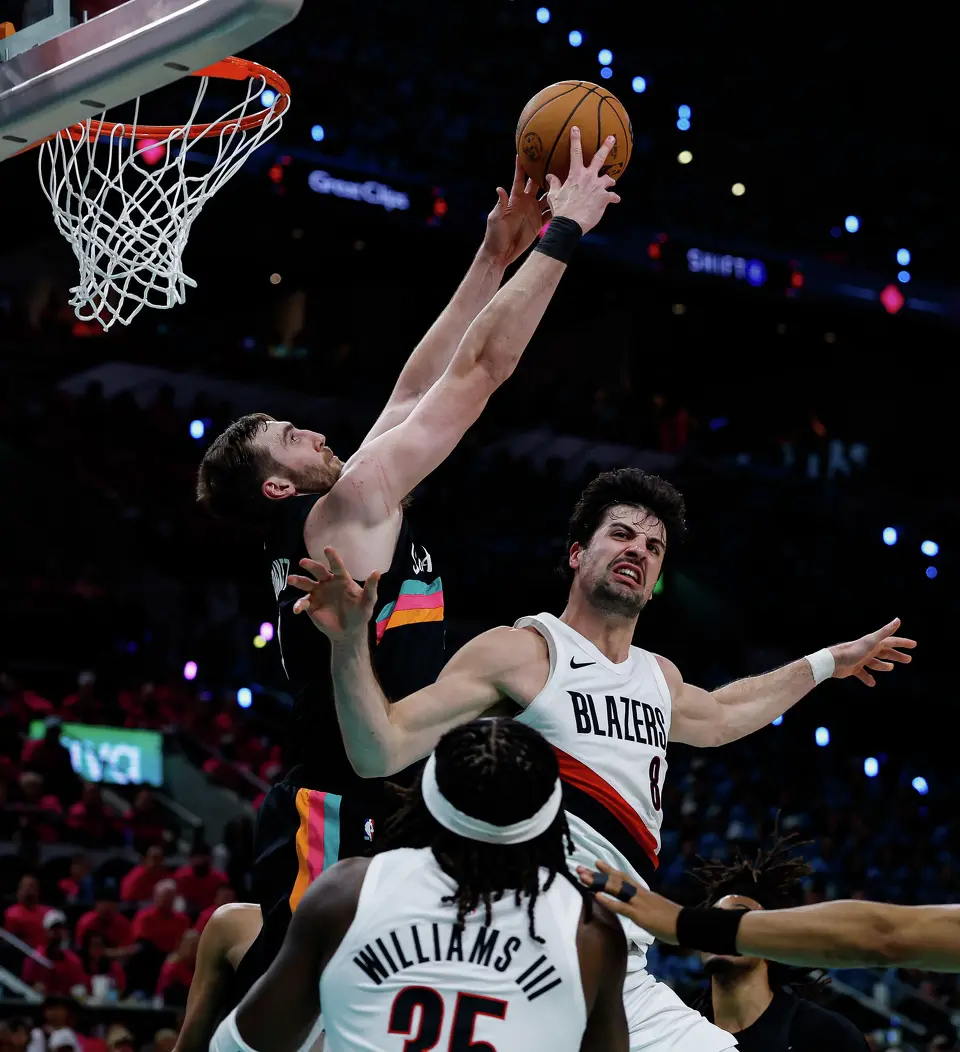 San Antonio Spurs center Luke Kornet (7) blocks a shot attempt by Portland Trail Blazers forward Deni Avdija (8) during the second half of Game 1 of a first-round NBA playoff series at Frost Bank Center, Sunday, April 19, 2026, in San Antonio. The Spurs won 111-98.