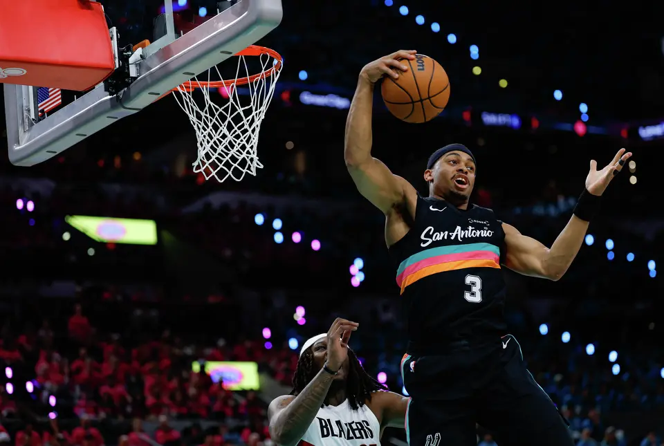 San Antonio Spurs forward Keldon Johnson (3) rebounds the ball during the first half of Game 1 of a first-round NBA playoff series against the Portland Trail Blazers at Frost Bank Center, Sunday, April 19, 2026, in San Antonio.