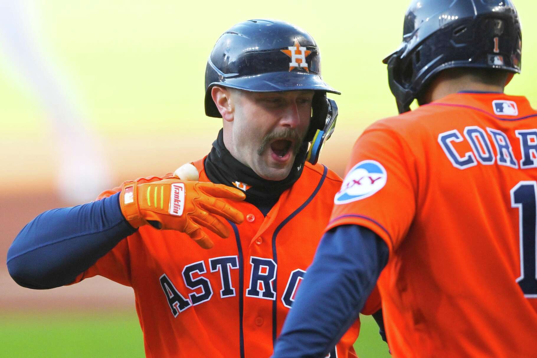 Houston Astros' Christian Walker, left, celebrates after his two-run home run with teammate Carlos Correa in the first inning of a baseball game against the Cleveland Guardians in Cleveland, Monday, April 20, 2026. (AP Photo/David Richard)