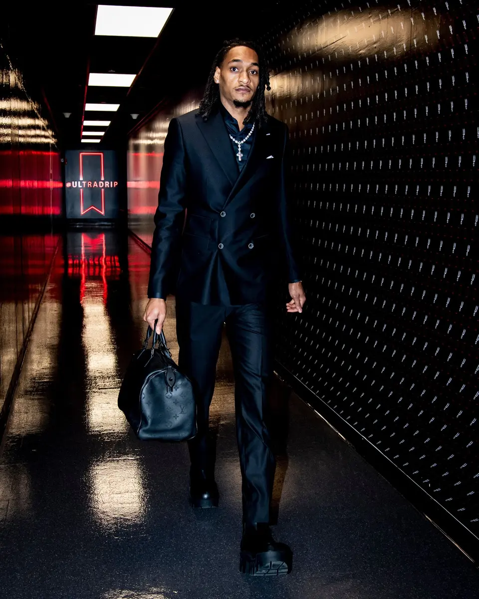 Forward Devin Vassell arrives at the Frost Bank Center for Game 1 of the Spurs' playoff series with Portland on Sunday, April 19, 2026 dressed in a custom-made black suit bought by teammate Kelly Olynyk.