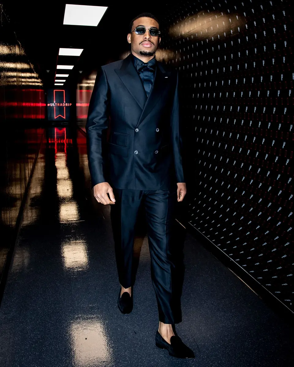 Forward Keldon Johnson arrives at the Frost Bank Center for Game 1 of the Spurs' playoff series with Portland on Sunday, April 19, 2026 dressed in a custom-made black suit bought by teammate Kelly Olynyk.