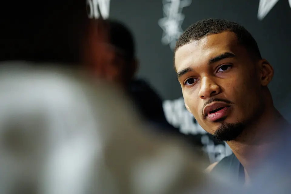 San Antonio Spurs’ Victor Wembanyama talks to reporters about being named NBA Defensive Player of the Year during shoot around practice at Victory Capital Performance Center in San Antonio, Tuesday, April 21, 2026. The 22-year-old Frenchman is the youngest player to win the award and the first to do so unanimously.