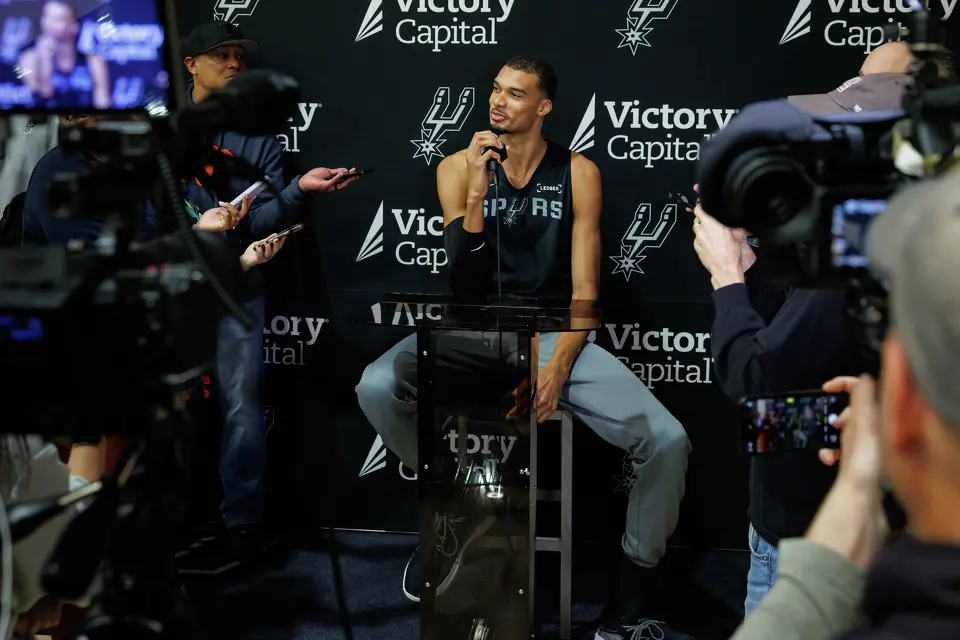 San Antonio Spurs’ Victor Wembanyama talks to reporters about being named NBA Defensive Player of the Year during shoot around practice at Victory Capital Performance Center in San Antonio, Tuesday, April 21, 2026. The 22-year-old Frenchman is the youngest player to win the award and the first to do so unanimously.