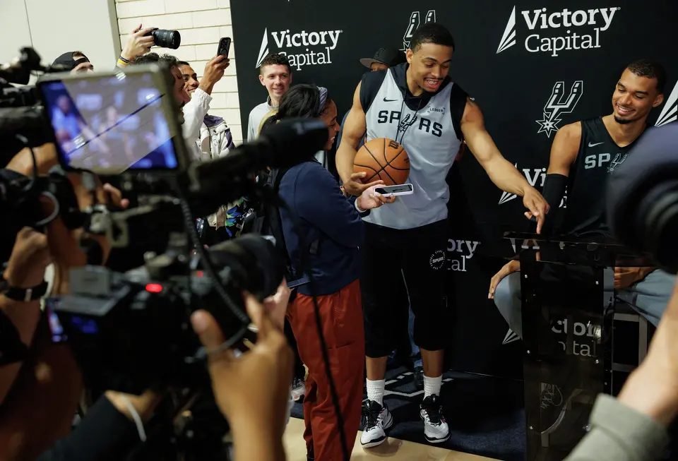 San Antonio Spurs forward Keldon Johnson says, “Best player in the world,” as he interrupts teammate Victor Wembanyama’s interview while reporters ask Wembanyama about being named NBA Defensive Player of the Year during shootaround at Victory Capital Performance Center in San Antonio, Tuesday, April 21, 2026. The 22-year-old Frenchman is the youngest player to win the award and the first to win it unanimously.