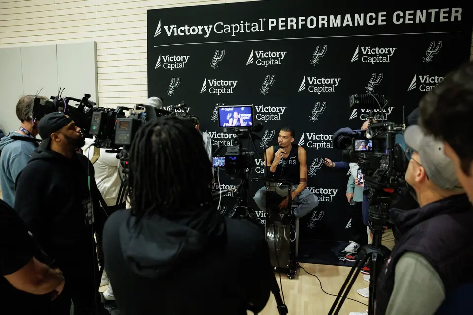 San Antonio Spurs’ Victor Wembanyama talks to reporters about being named NBA Defensive Player of the Year during shoot around practice at Victory Capital Performance Center in San Antonio, Tuesday, April 21, 2026. The 22-year-old Frenchman is the youngest player to win the award and the first to do so unanimously.