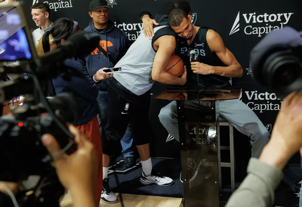 San Antonio Spurs forward Keldon Johnson interrupts teammate Victor Wembanyama’s interview as reporters ask Wembanyama about being named NBA Defensive Player of the Year during shootaround at Victory Capital Performance Center in San Antonio, Tuesday, April 21, 2026.