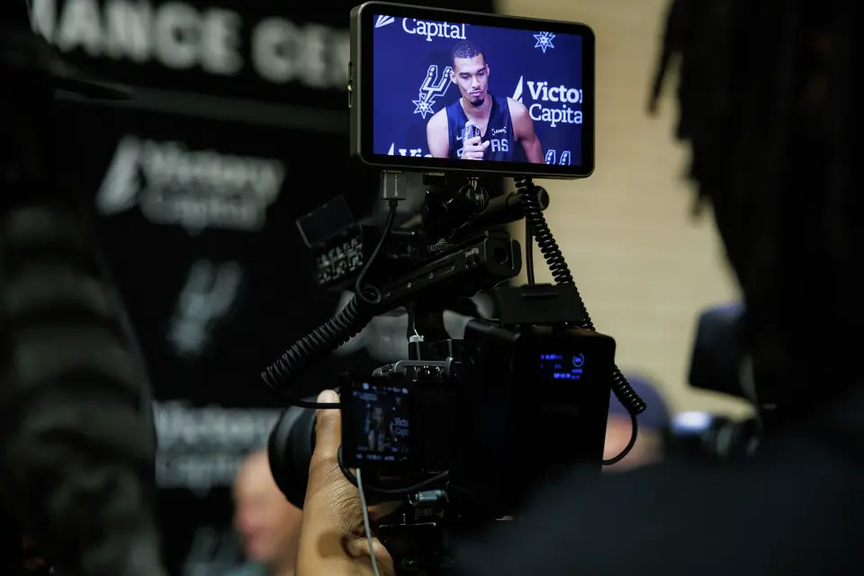 San Antonio Spurs’ Victor Wembanyama talks to reporters about being named NBA Defensive Player of the Year during shoot around practice at Victory Capital Performance Center in San Antonio, Tuesday, April 21, 2026. The 22-year-old Frenchman is the youngest player to win the award and the first to do so unanimously.