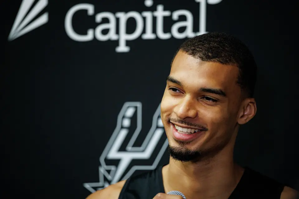 San Antonio Spurs’ Victor Wembanyama talks to reporters about being named NBA Defensive Player of the Year during shoot around practice at Victory Capital Performance Center in San Antonio, Tuesday, April 21, 2026. The 22-year-old Frenchman is the youngest player to win the award and the first to do so unanimously.