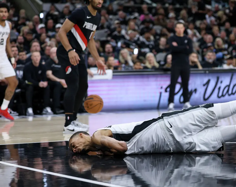 San Antonio Spurs center Victor Wembanyama (1) hits his head on the court during the first half of Game 2 of a first-round NBA playoff series between the San Antonio Spurs and the Portland Trail Blazers at Frost Bank Center in San Antonio, Tuesday, April 21, 2026. He sat out the rest of the game in concussion protocol.