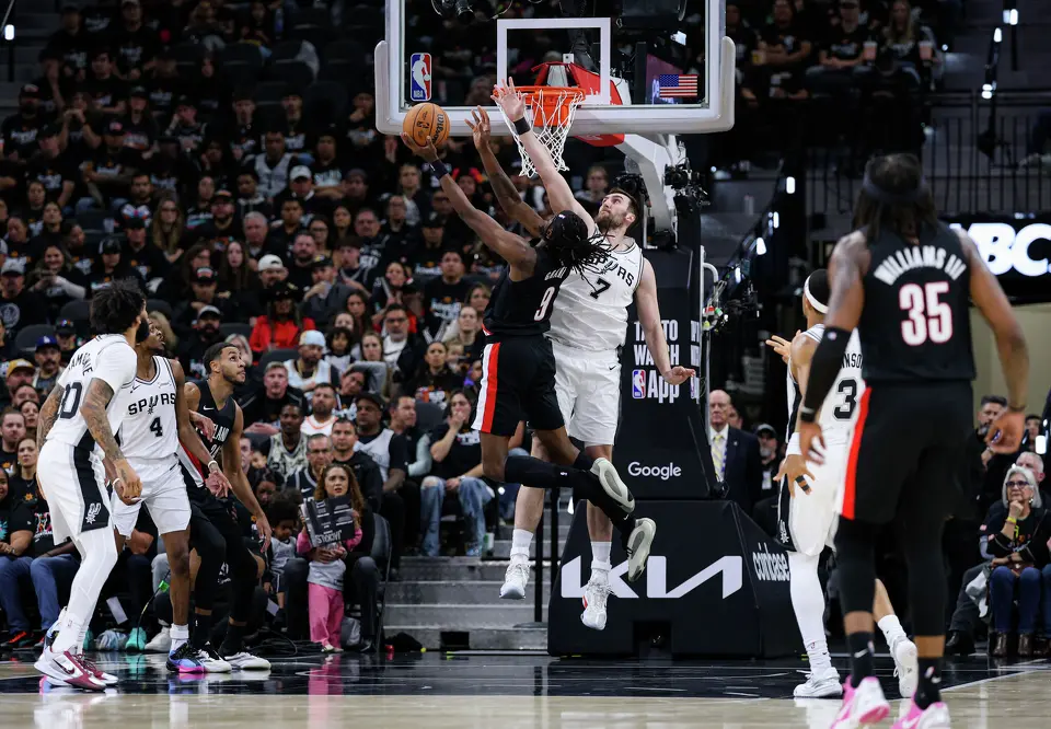 San Antonio Spurs center Luke Kornet (7) blocks Portland Trail Blazers forward Jerami Grant (9) under the net during the first half of Game 2 of a first-round NBA playoff series at Frost Bank Center in San Antonio, Tuesday, April 21, 2026.