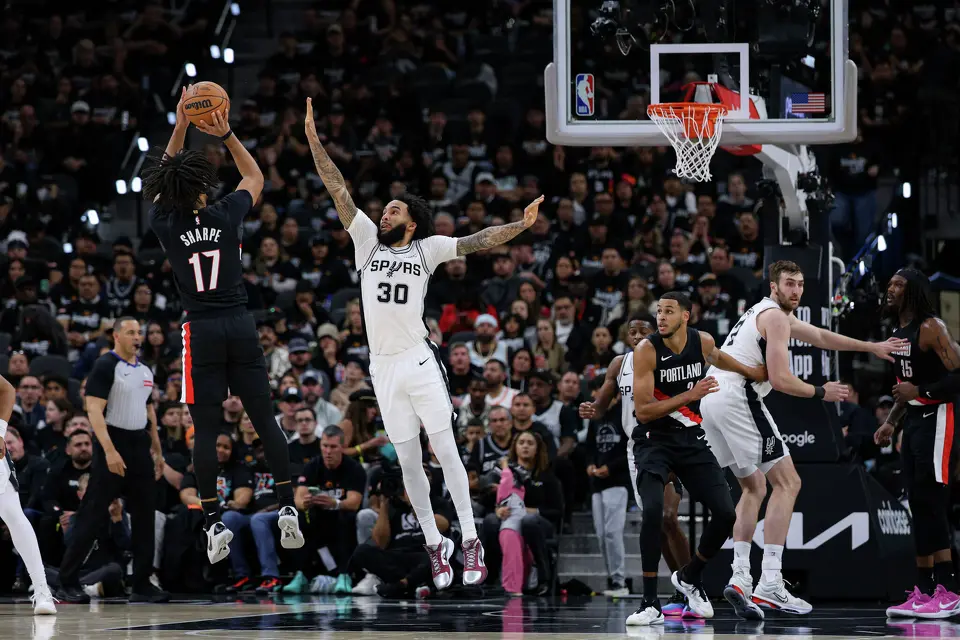 Portland Trail Blazers guard Shaedon Sharpe (17) shoots over San Antonio Spurs forward Julian Champagnie (30) during the first half of Game 2 of a first-round NBA playoff series at Frost Bank Center in San Antonio, Tuesday, April 21, 2026.