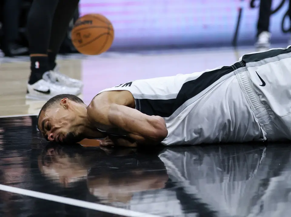 San Antonio Spurs forward Victor Wembanyama (1) hits his head on the court during the first half of Game 2 of a first-round NBA playoff series between the San Antonio Spurs and the Portland Trail Blazers at Frost Bank Center in San Antonio, Tuesday, April 21, 2026. He sat out the rest of the game due to a concussion.