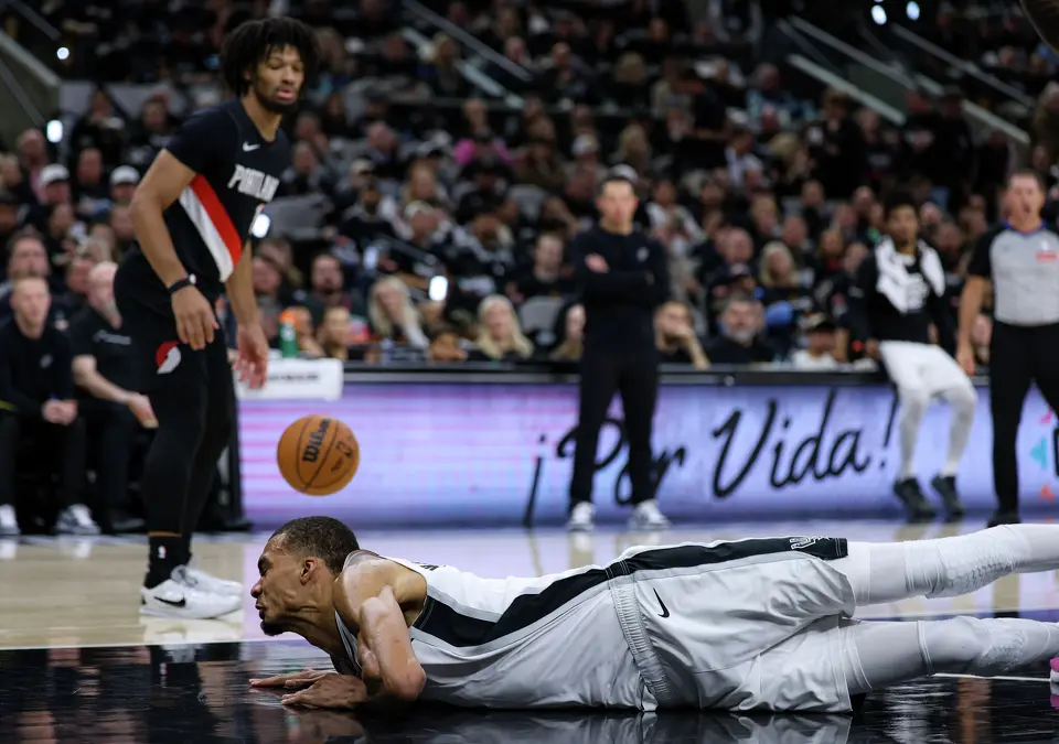 San Antonio Spurs forward Victor Wembanyama (1) hits his head on the court during the first half of Game 2 of a first-round NBA playoff series between the San Antonio Spurs and the Portland Trail Blazers at Frost Bank Center in San Antonio, Tuesday, April 21, 2026. He did not return to the game.
