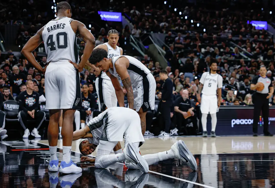 Victor Wembanyama reacts after taking a hard fall during the first half of Game 2 of a first-round NBA playoff series against the Portland Trail Blazers, Tuesday, April 21, 2026, in San Antonio. He did not return to the game.