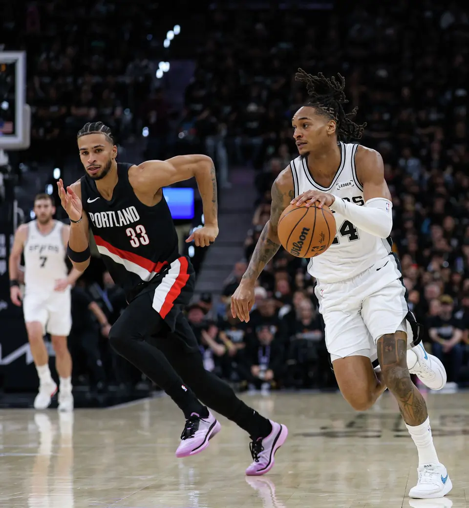 San Antonio Spurs guard Devin Vassell (24) drives past Portland Trail Blazers forward Toumani Camara (33) during the second half of Game 2 of a first-round NBA playoff series between the San Antonio Spurs and the Portland Trail Blazers at Frost Bank Center in San Antonio, Tuesday, April 21, 2026.
