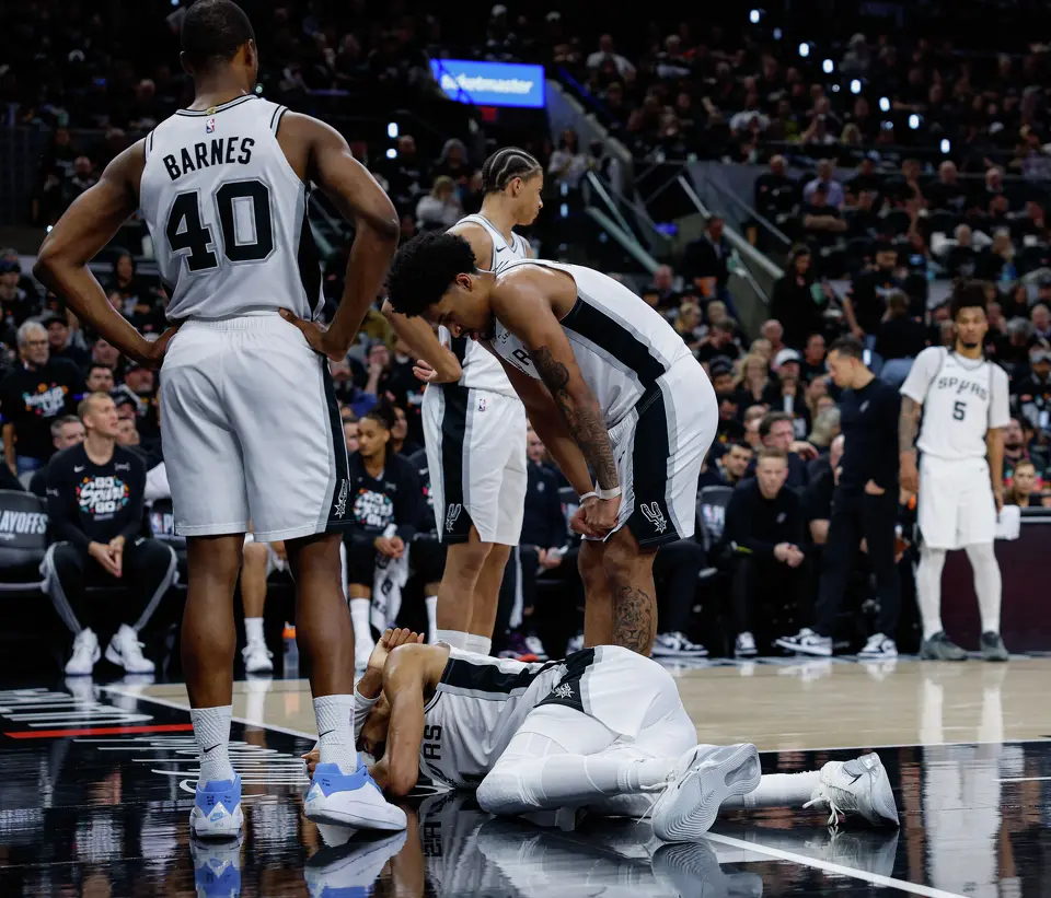 Victor Wembanyama reacts after taking a hard fall during the first half of Game 2 of a first-round NBA playoff series against the Portland Trail Blazers, Tuesday, April 21, 2026, in San Antonio. He did not return to the game.