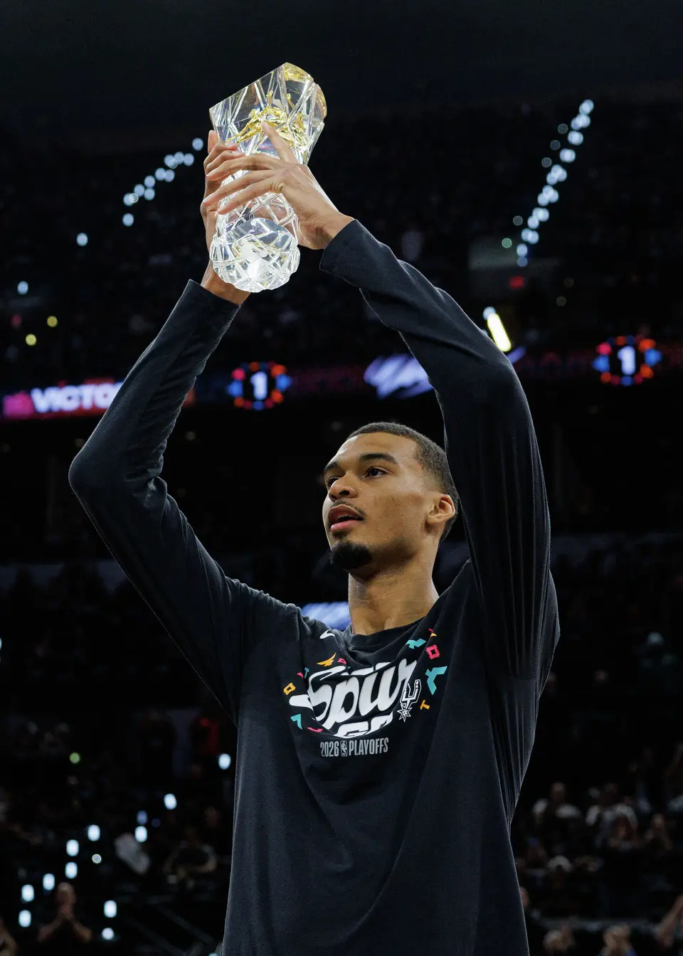 San Antonio Spurs forward Victor Wembanyama hoists his NBA Defensive Player of the Year trophy in the air before Game 2 of a first-round NBA playoffs basketball series in San Antonio, Tuesday, April 21, 2026