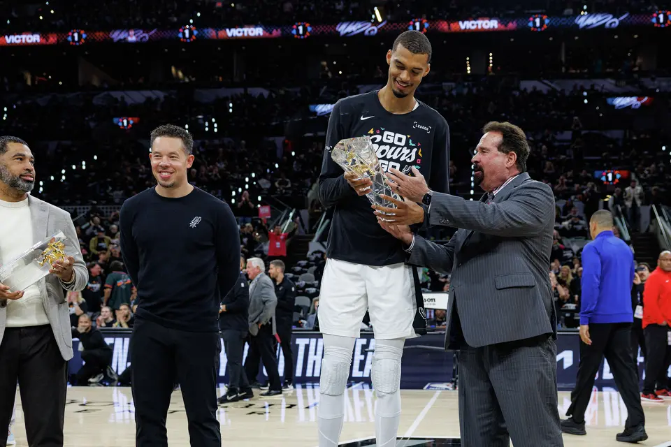 San Antonio Spurs forward Victor Wembanyama receives his NBA Defensive Player of the Year trophy before Game 2 of a first-round NBA playoffs basketball series against the Portland Trail Blazers in San Antonio, Tuesday, April 21, 2026