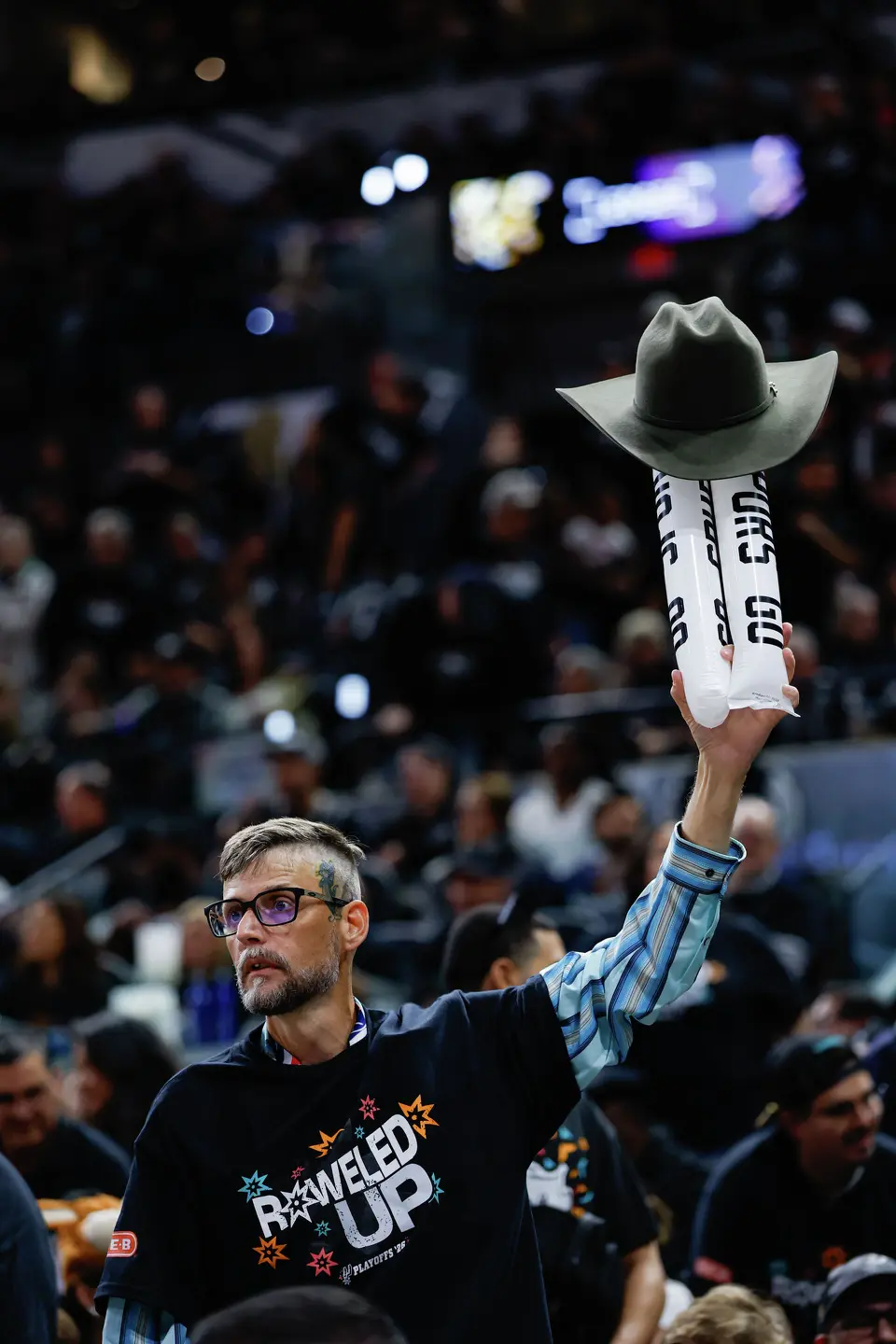 A fan holds up his cowboy hat with noisemakers during the second half of Game 2 of a first-round NBA playoff series against the Portland Trail Blazers at Frost Bank Center in San Antonio, Tuesday, April 21, 2026. The Spurs fell 106-103, evening the series at 1-1.
