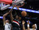 Portland Trail Blazers center Robert Williams III (35) dunks over San Antonio Spurs forward Carter Bryant (11) and forward Keldon Johnson (3) during the second half of Game 2 of a first-round NBA playoff series at Frost Bank Center in San Antonio, Tuesday, April 21, 2026. The Spurs fell 106-103, evening the series at 1-1.