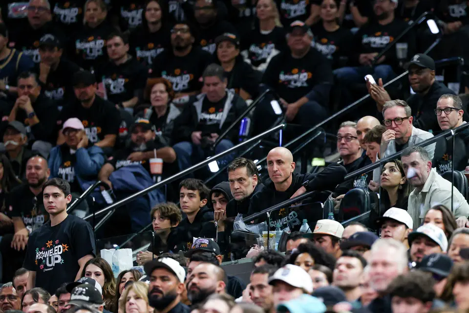 Former San Antonio Spurs and Portland Trail Blazers player Fabricio Oberto, center left, watches the game with former Spurs player Manu Ginobili during the second half of Game 2 of a first-round NBA playoff series at Frost Bank Center in San Antonio, Tuesday, April 21, 2026.