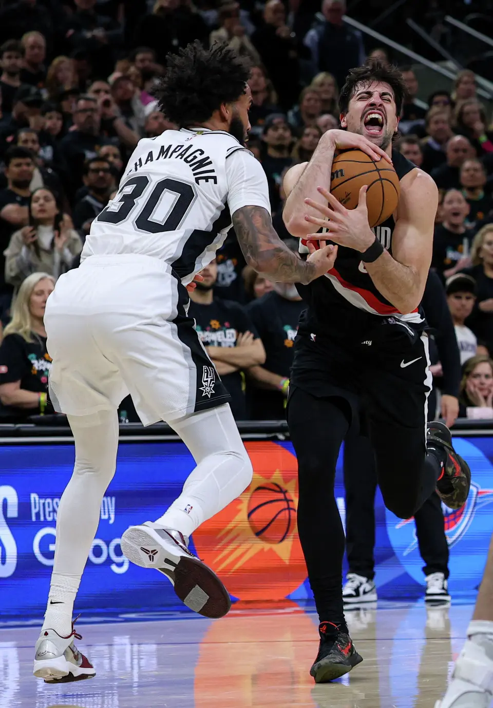 San Antonio Spurs forward Julian Champagnie (30) guards Portland Trail Blazers forward Deni Avdija (8) during the second half of Game 2 of a first-round NBA playoff series at Frost Bank Center in San Antonio, Tuesday, April 21, 2026. The Spurs fell 106-103, evening the series at 1-1.