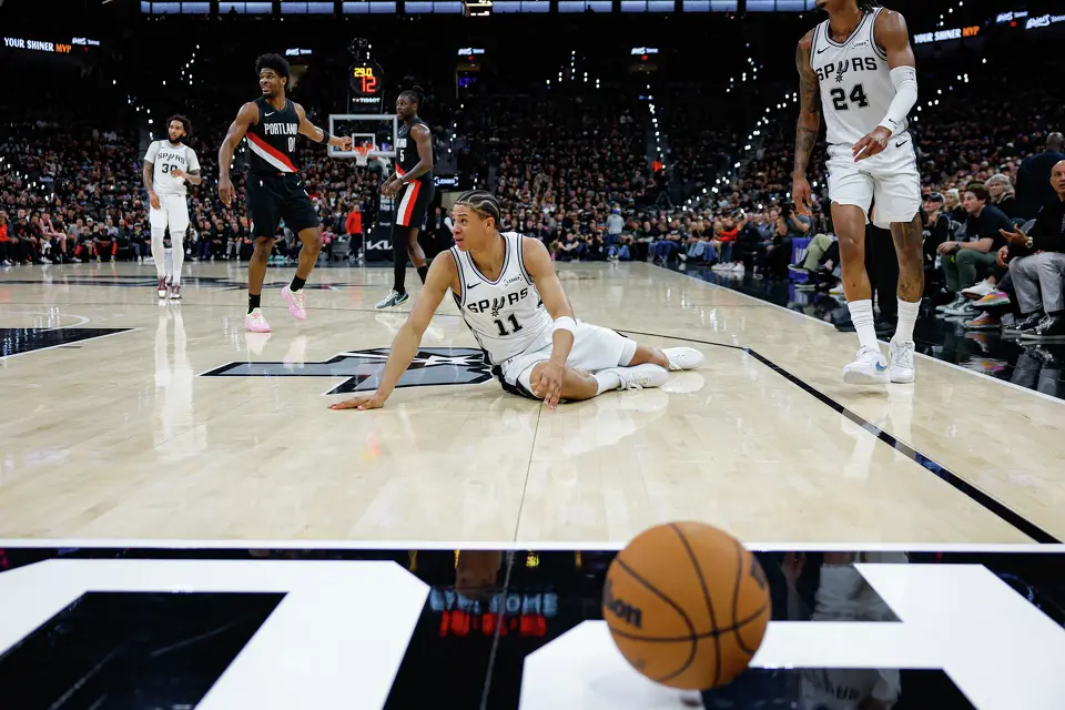 San Antonio Spurs forward Carter Bryant (11) reacts as the referees call for the Portland Trail Blazers to receive the ball during the first half of Game 2 of a first-round NBA playoff at Frost Bank Center in San Antonio, Tuesday, April 21, 2026.