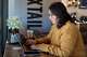 Lauren Contreras, 40, works from her laptop at Foxtail Coffee Co., in Flagstaff, Ariz., on Monday, April 20, 2026.